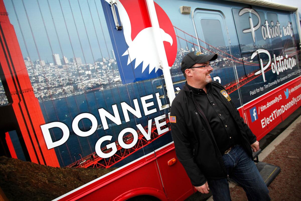 Assemblyman Tim Donnelly, a Republican candidate for governor, greets people in front of his campaign's RV in February. He's facing a campaign finance complaint saying he did not properly report the vehicle.