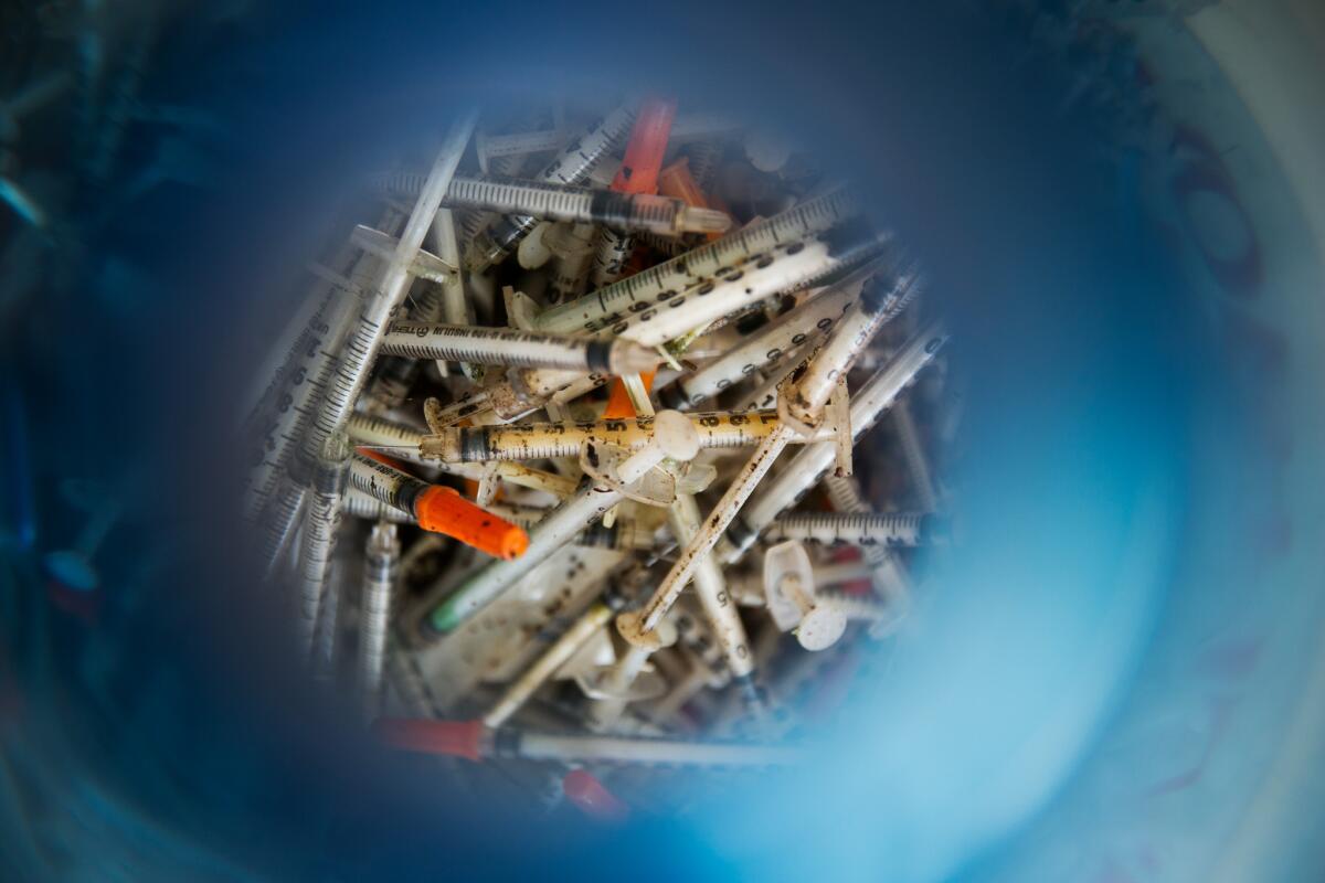 L.A. County supervisors approved a voluntary plan for disposing of drugs and needles. Above, needles found in Ballona Wetlands in 2014.