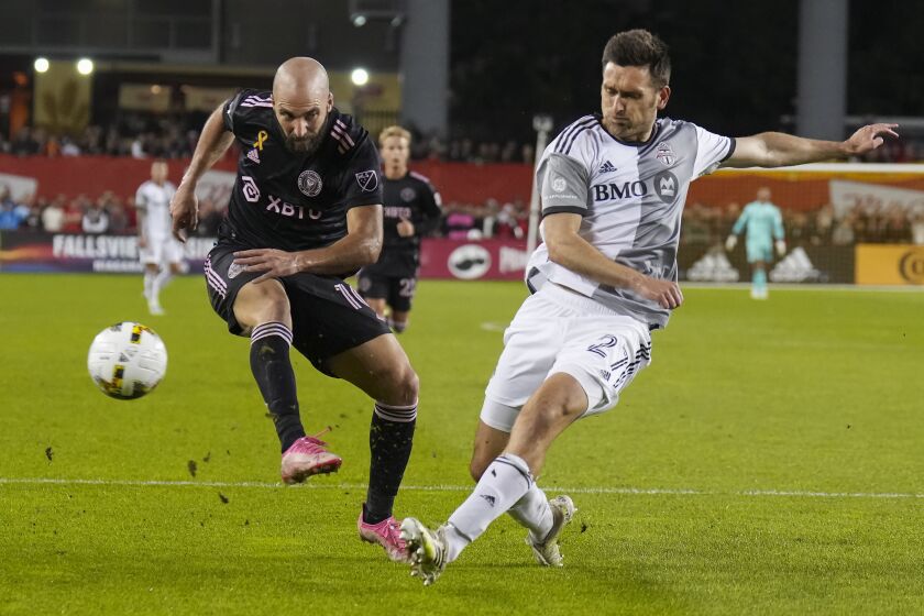 Toronto FC defender Shane O'Neill, right, blocks a shot by Inter Miami forward Gonzalo Higuaín (10) during the first half of an MLS soccer match Friday, Sept. 30, 2022 in Toronto. (Nathan Denette/The Canadian Press via AP)
