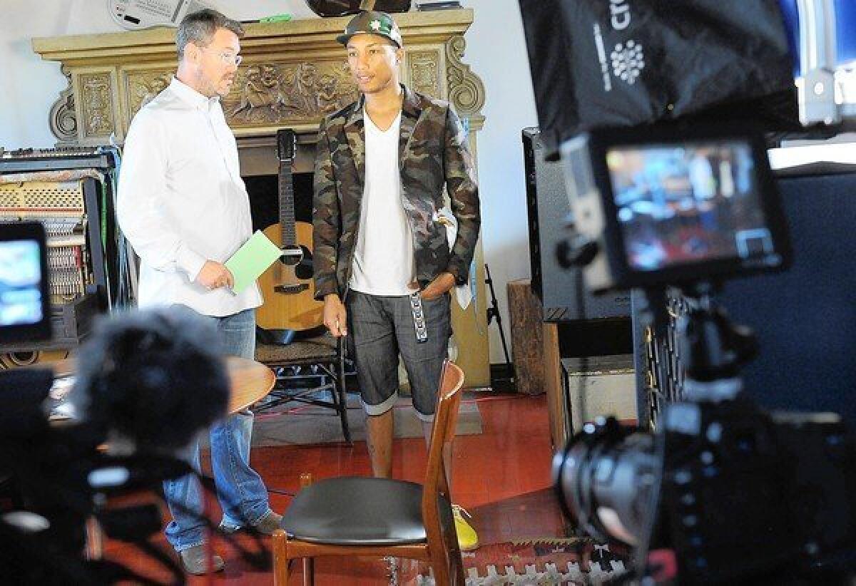 Uncommon Content has so far produced seven Web series, one of which features musician, producer and entrepreneur Pharrell Williams. Above, Uncommon Content Chief Executive Kevin Law, left, and Williams chat before a taping in Los Angeles.