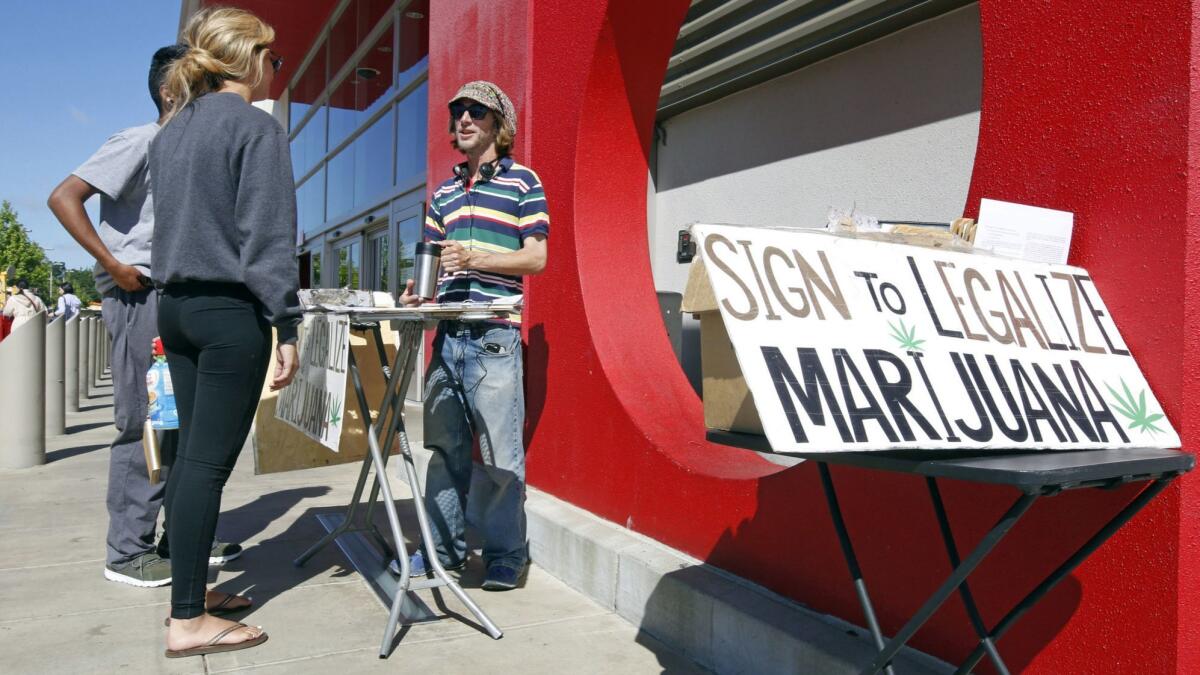 A supporter of legal marijuana gathers signatures on what became Proposition 64 outside a store in Sacramento on April 23, 2016.