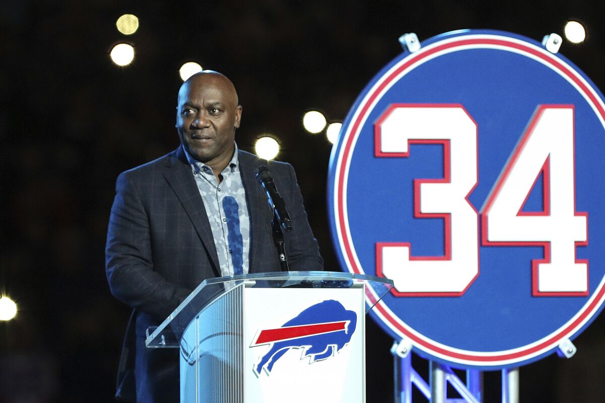 FILE - Buffalo Bills Hall of Fame running back Thurman Thomas speaks during halftime of an NFL football game between New England Patriots and Buffalo Bills in Orchard Park, N.Y., Oct. 29, 2018. Thurman Thomas tells The Associated Press he and several former teammates are coming together in Buffalo this week to help support families of the shooting victimsWLD (AP Photo/Chris Cecere)
