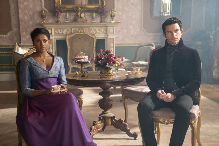 Men and women sitting over a cup of tea, a little apart