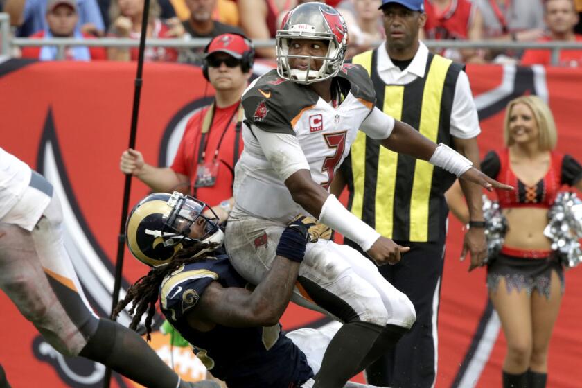 Buccaneers quarterback Jameis Winston just releases a pass before Rams linebacker Mark Barron can sack him.