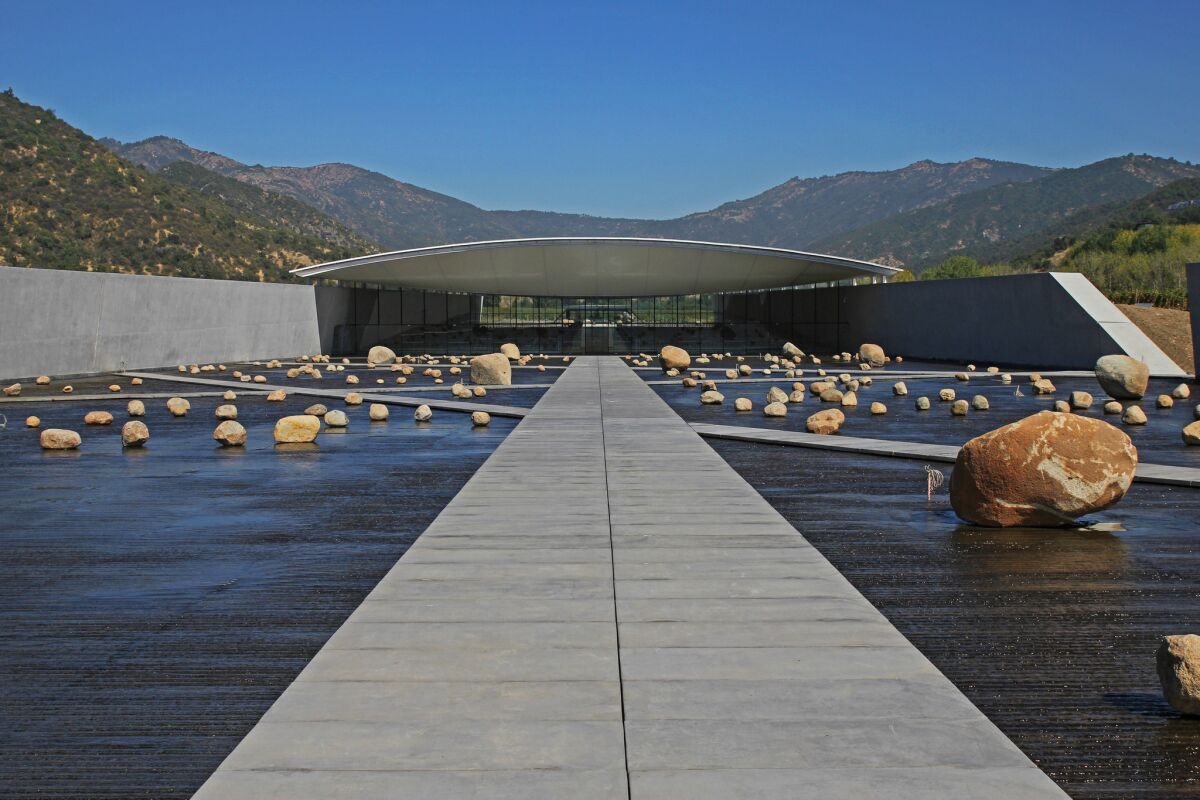 A dramatic water plaza punctuated by rocks greets visitors to Vik Vineyard in Chile's Central Valley. The winery complex was designed by Smiljan Radic, who did the Serpentine Pavilion in London in 2014.