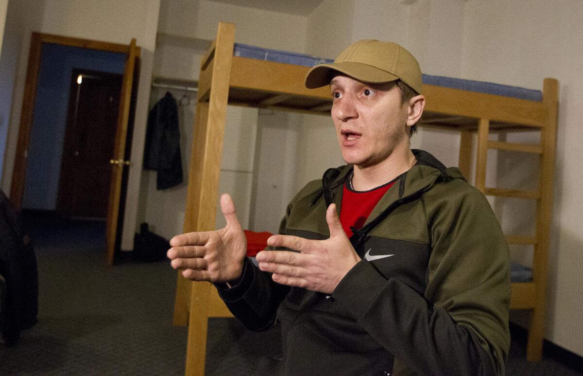 An evacuee from Mariupol speaks during an interview.