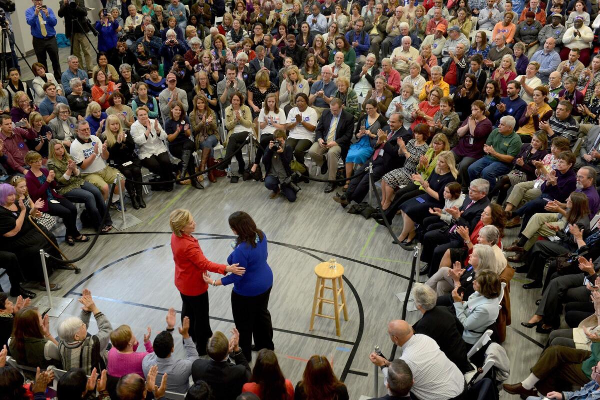 Hillary Rodham Clinton reaches out to Nicole Hockley, whose child was killed at Sandy Hook Elementary School, during a town hall event at Manchester Community College Oct. 5, 2015 in Manchester, New Hampshire.