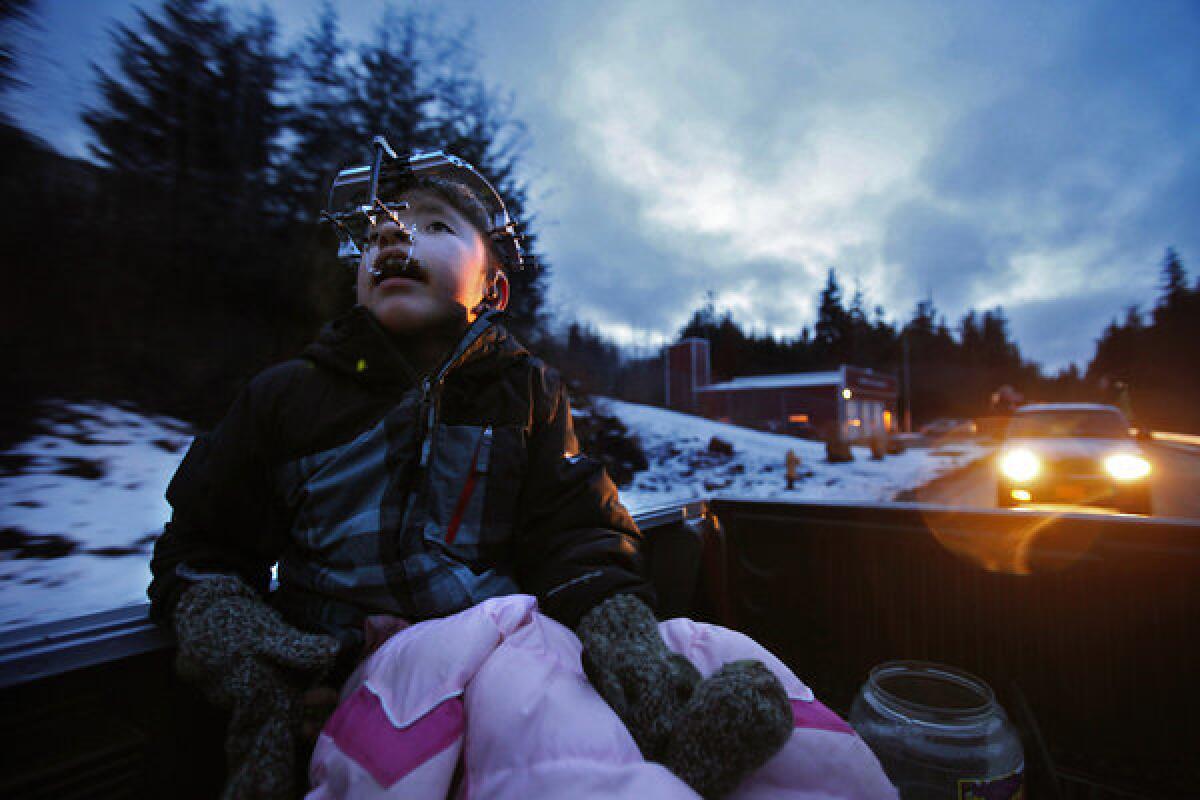 James Weatherwax, 11, rides in the back of his grandfather's truck. James was born with Apert syndrome, a rare genetic mutation that fuses the skull prematurely, distorts the bones of the face and melds the muscles and bones of the fingers and toes.