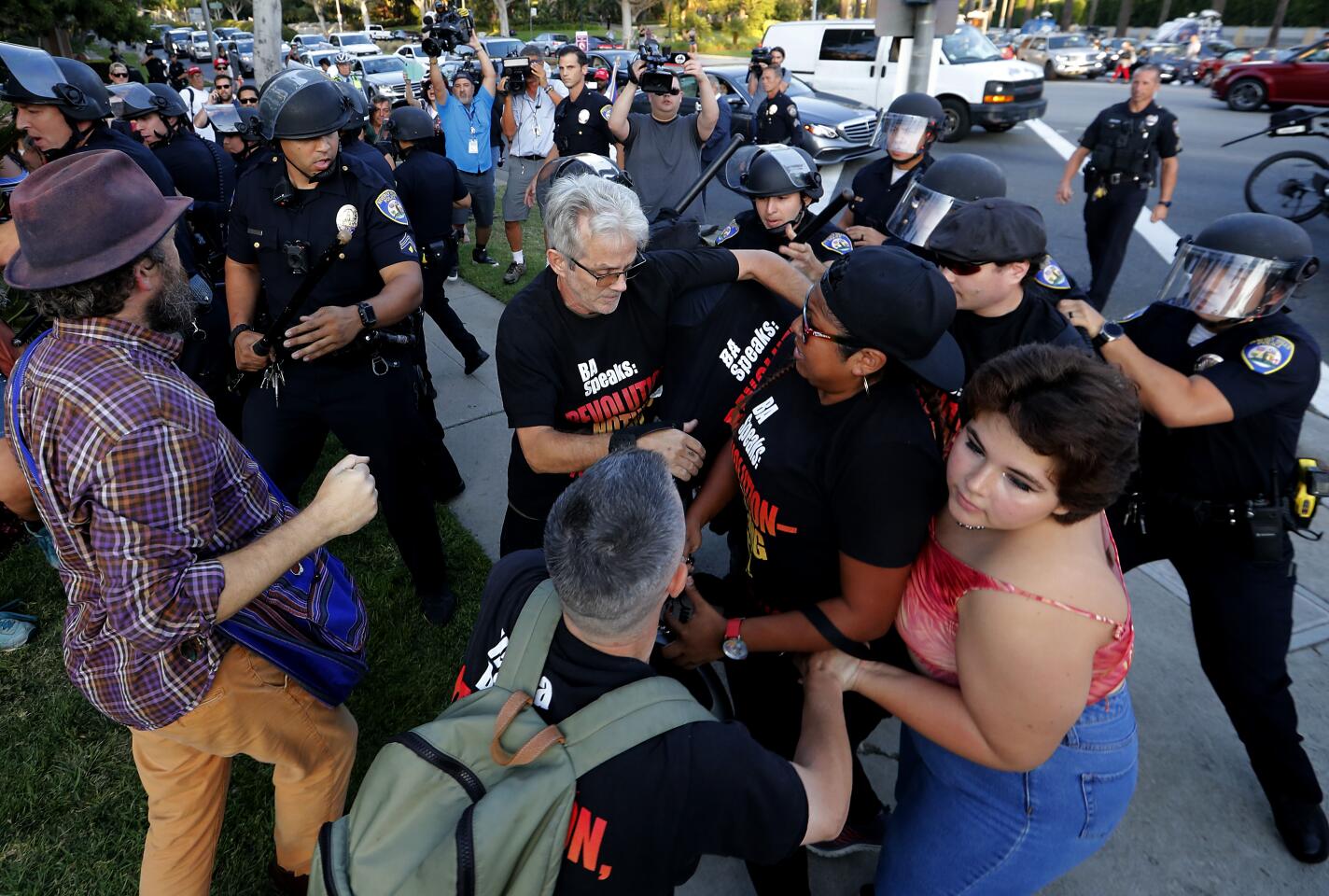 Beverly Hills police officers push back anti-Trump protesters.