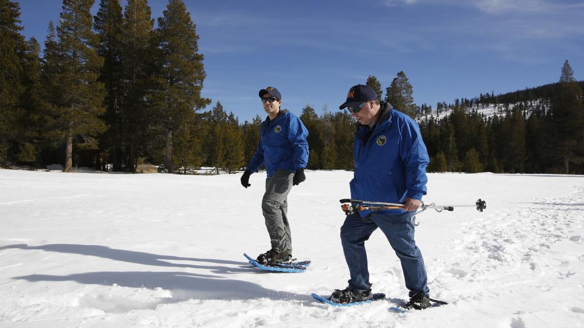 State water officials John King, left, and Michael Anderson after conducting the first snow survey of the season at Phillips Station on Jan. 3, 2019.