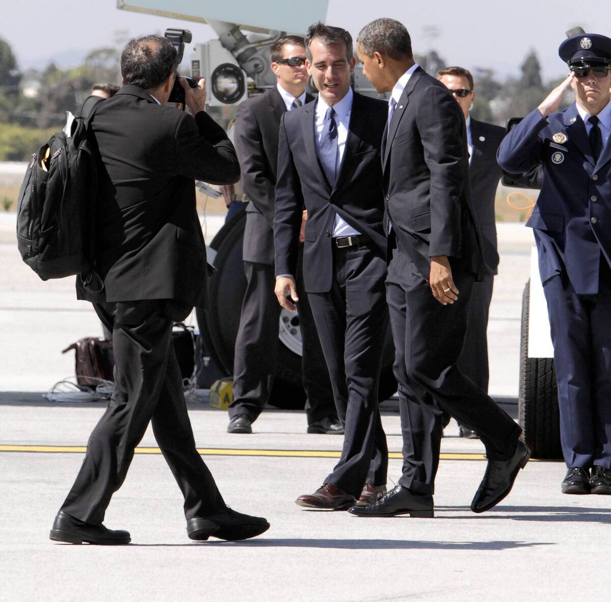 A White House photographer has unobstructed access to President Obama as he is greeted by Los Angeles Mayor Eric Garcetti at Los Angeles International Airport in August.