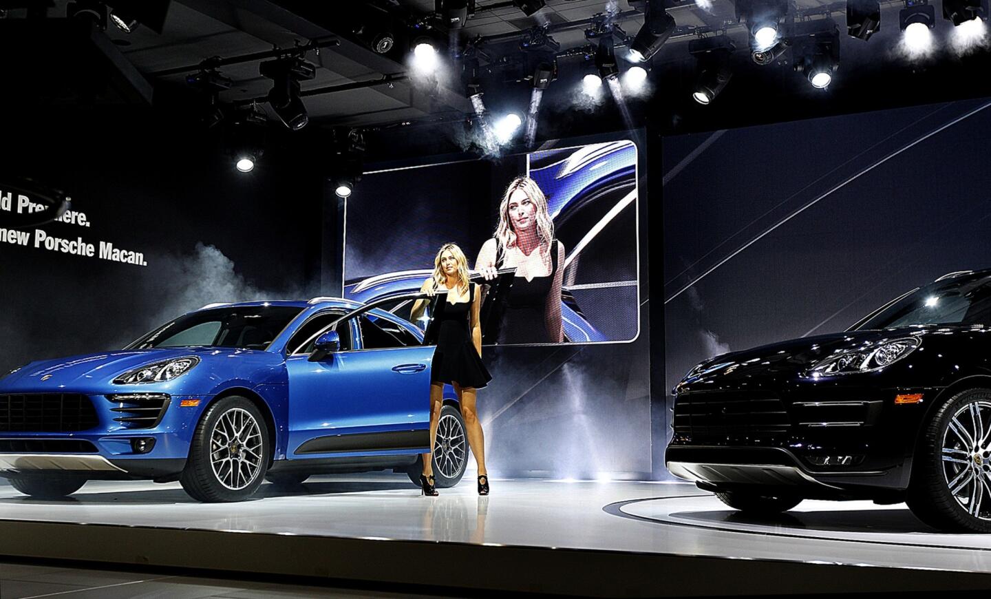 Tennis player Maria Sharapova steps out of a new Porsche Macan shortly after its revealing during the 2013 L.A. Auto Show.