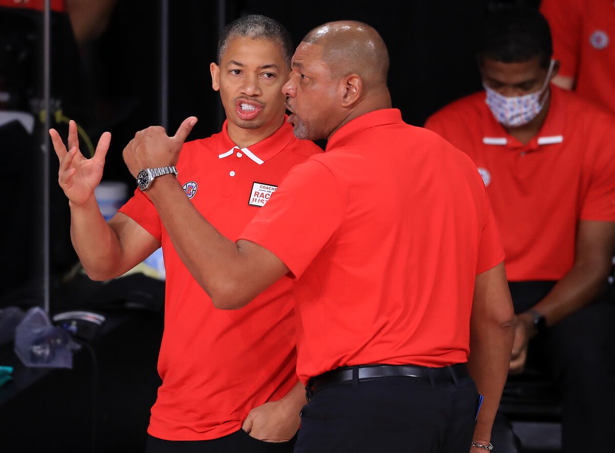 Tyronn Lue, left, talks with then-Clippers coach Doc Rivers.