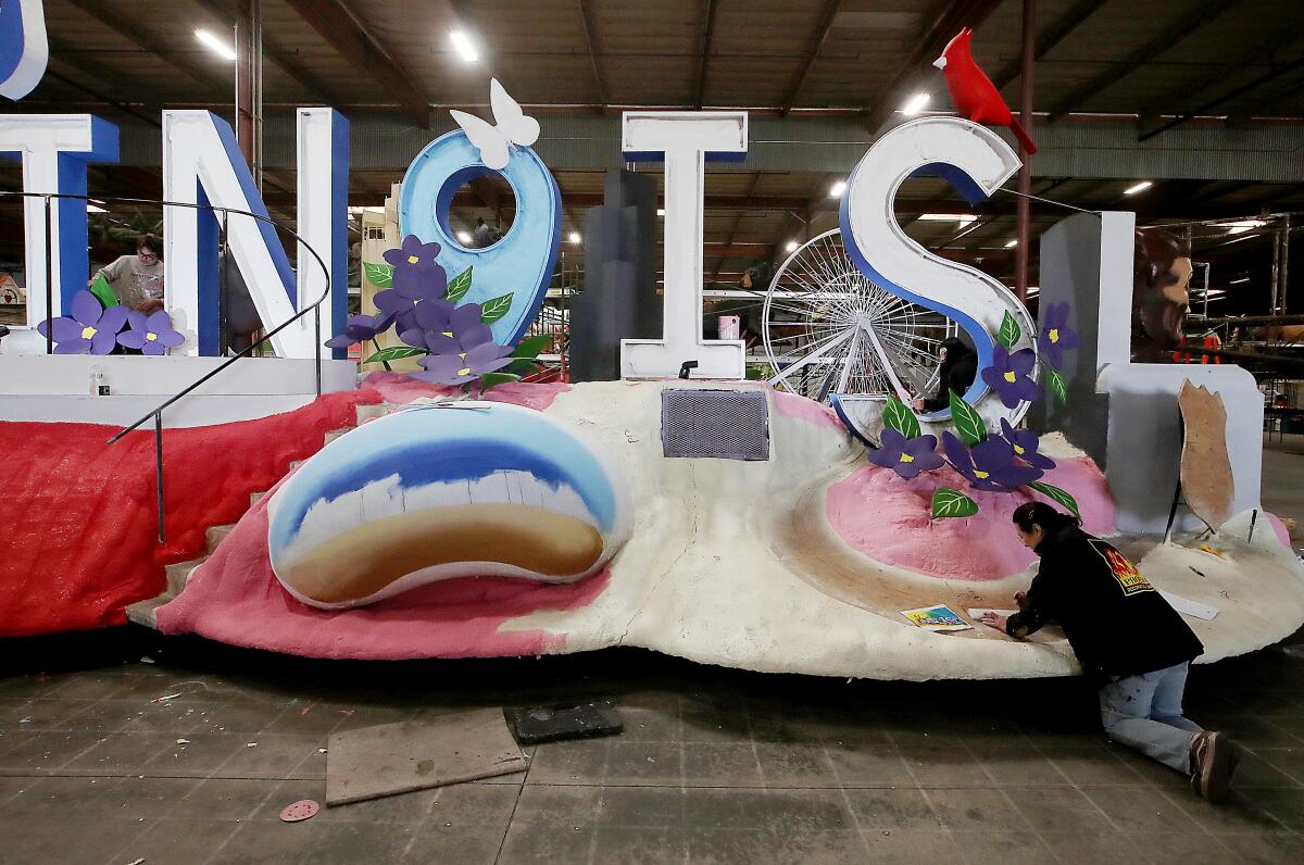 Workers at the Phoenix Decorating Co. prep Rose Parade floats at the company's facilities in Irwindale.