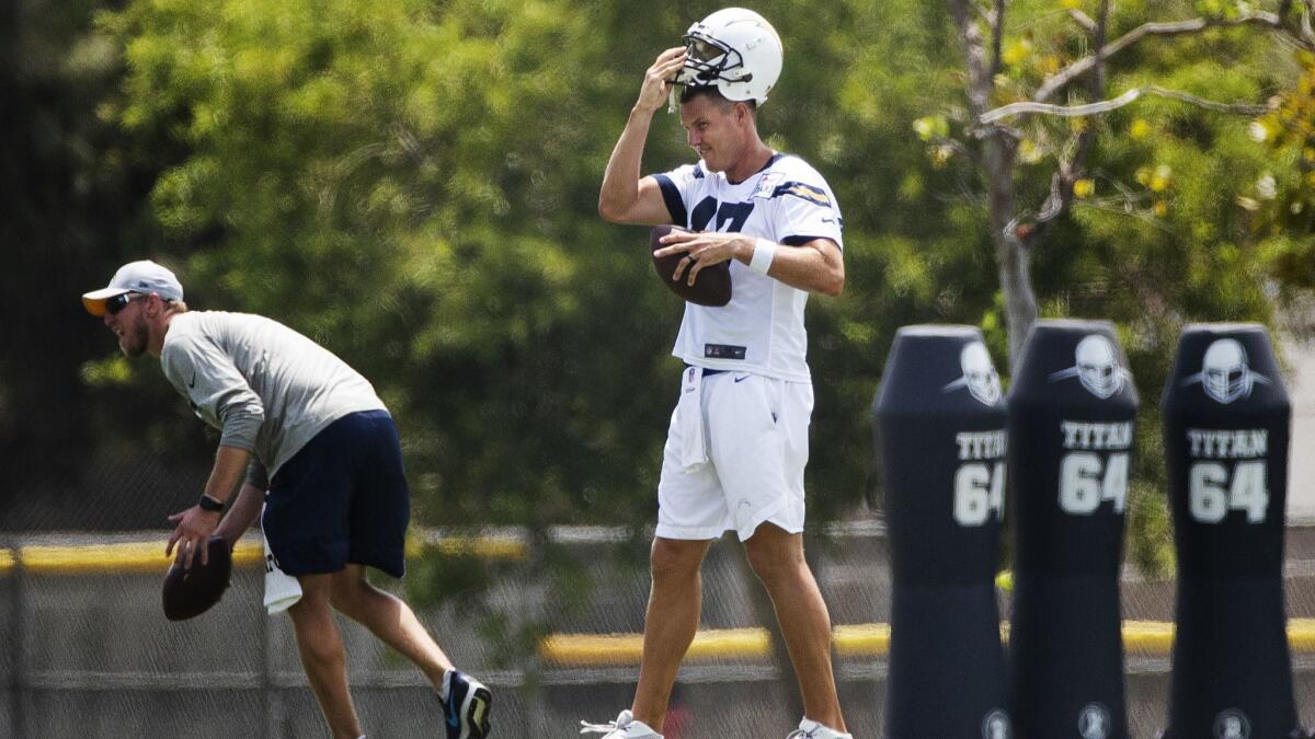 Chargers quarterback Phillip Rivers makes extra throws at the end of his day at training camp.