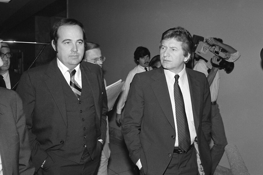 FILE - Rep. John Jenrette, D-S.C., right, accompanied by his lawyer Kenneth Robinson, walk outside the house Ethics Committee room in Washington on Dec. 10, 1980. Jenrette, who had been in declining health, died Friday, March 17, 2023 according to his obituary from Goldfinch Funeral Home in Conway, S.C. He was 86. (AP Photo/ John Duricka, file)