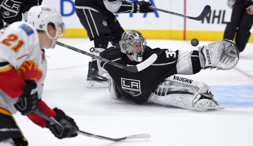 Kings goalie Jonathan Quick deflects a shot by Calgary left wing Mason Raymond on Dec. 22 at Staples Center.