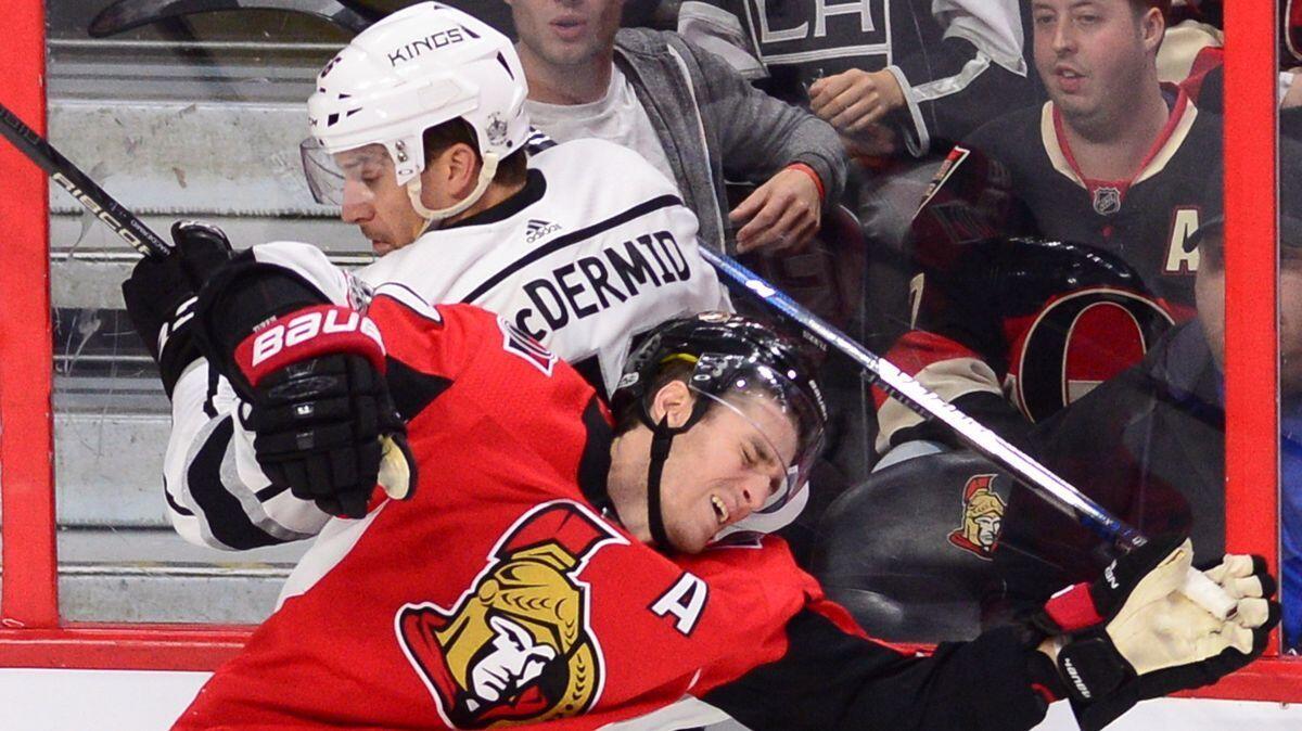 Ottawa Senators center Kyle Turris, front, and the Kings' Kurtis MacDermid collide during the third period on Tuesday.