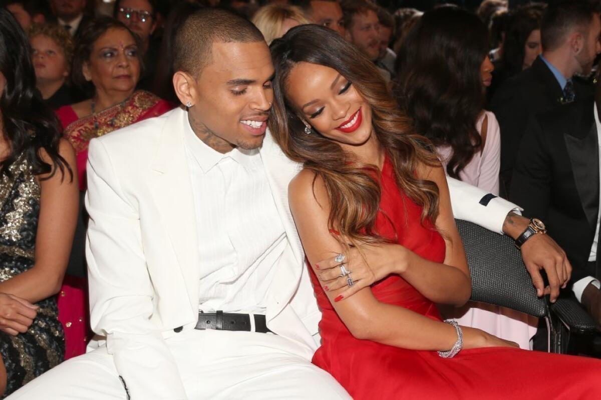 Singers Chris Brown and Rihanna get close at the 55th Grammy Awards on Sunday.