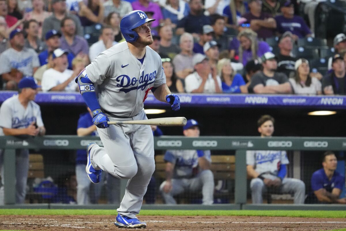 Max Muncy watches the flight of his solo home run off Colorado starter Kyle Freeland in the sixth inning Tuesday.