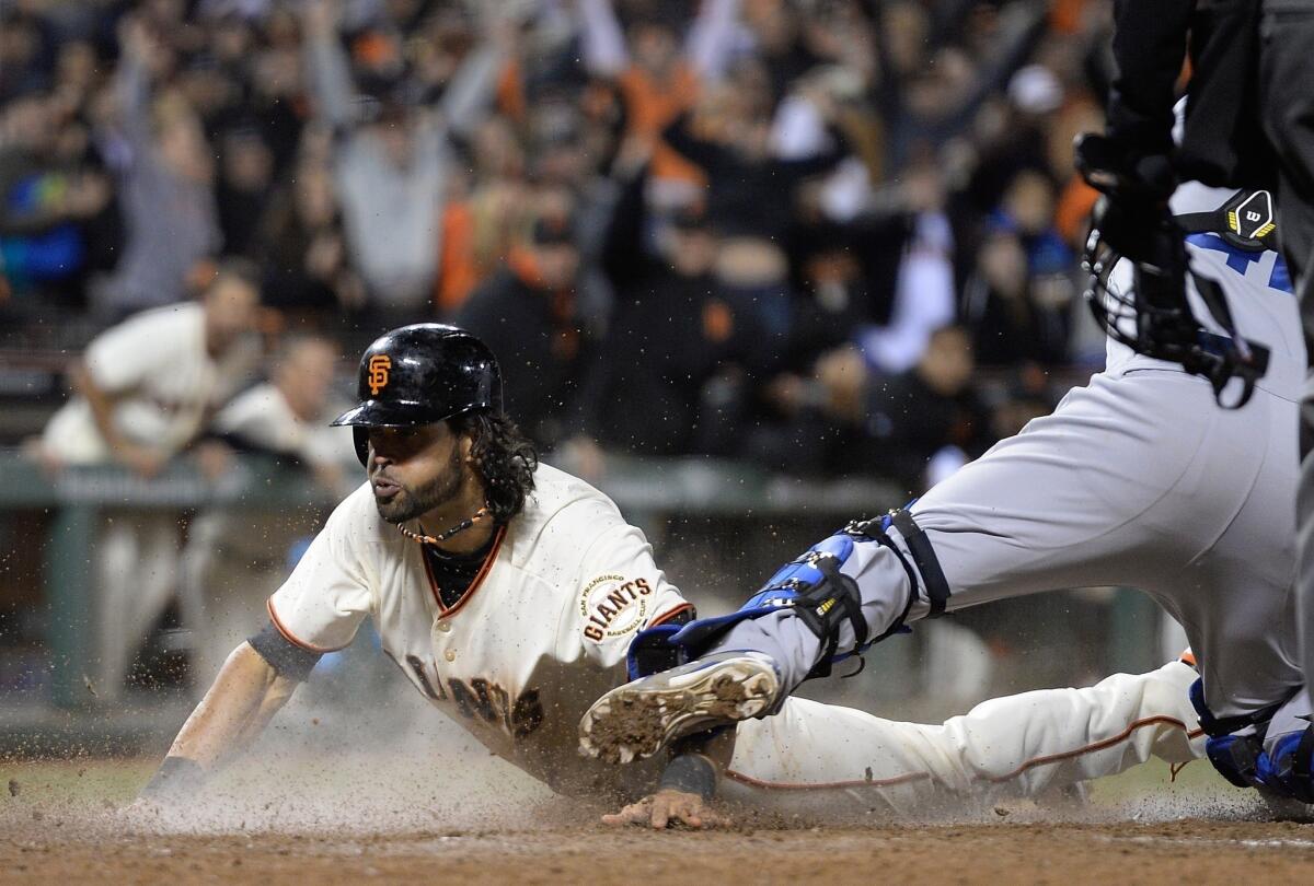 Giants center fielder Angel Pagan scores a game-tying run on an RBI double by Brandon Belt in the bottom of the ninth inning. San Francisco defeated the Dodgers, 3-2, in 12 innings.