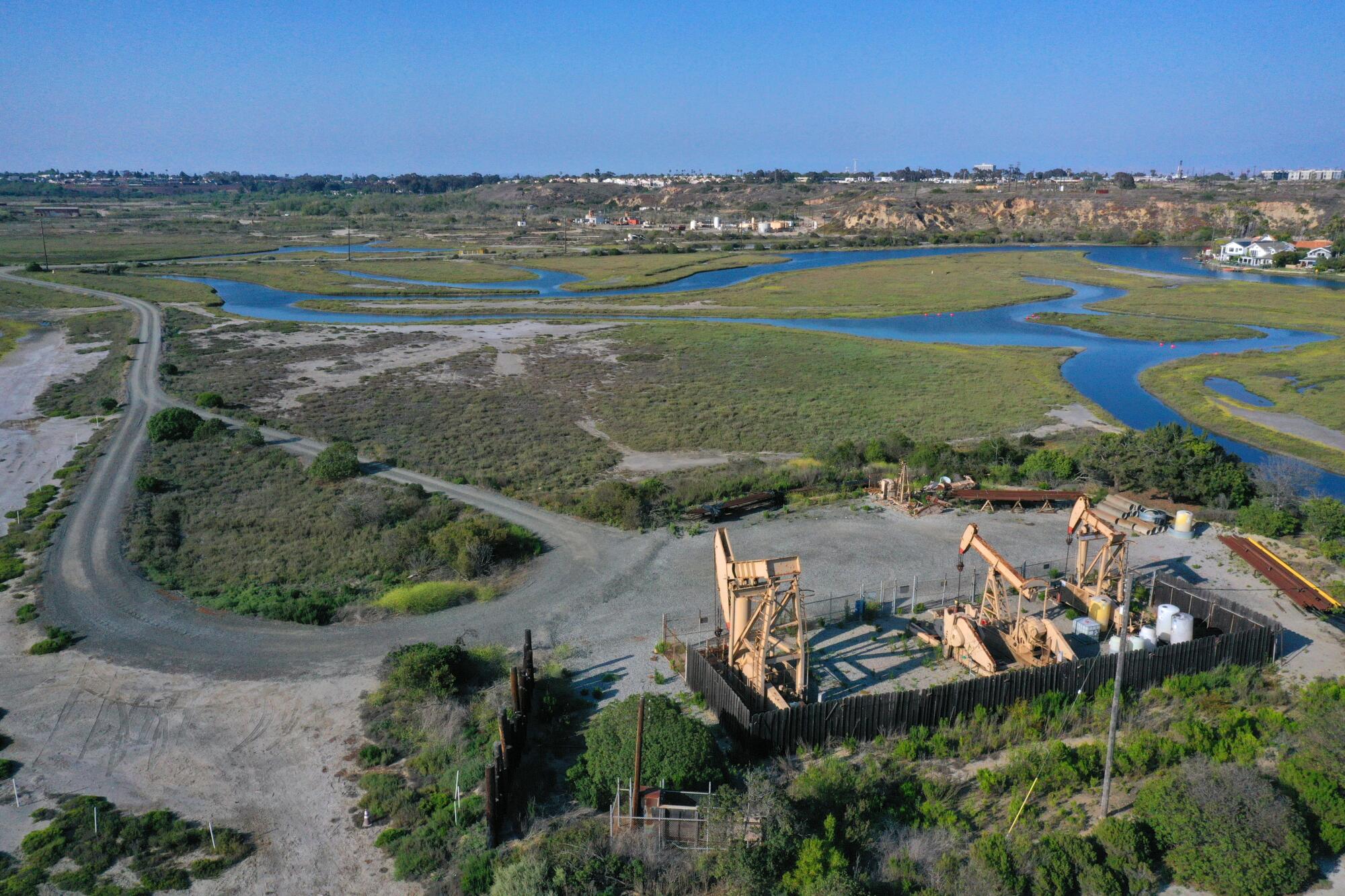 Bird's-eye view of oil pumps surrounded by wetlands 