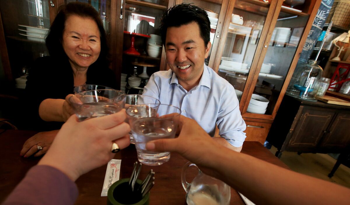 L.A. City Councilman-elect David Ryu celebrates his election victory with his mother, Michelle Ryu, left, and staff members Rachel Estrada and Andrew Jiang at Epicurean Umbrella in Los Feliz on Wednesday.