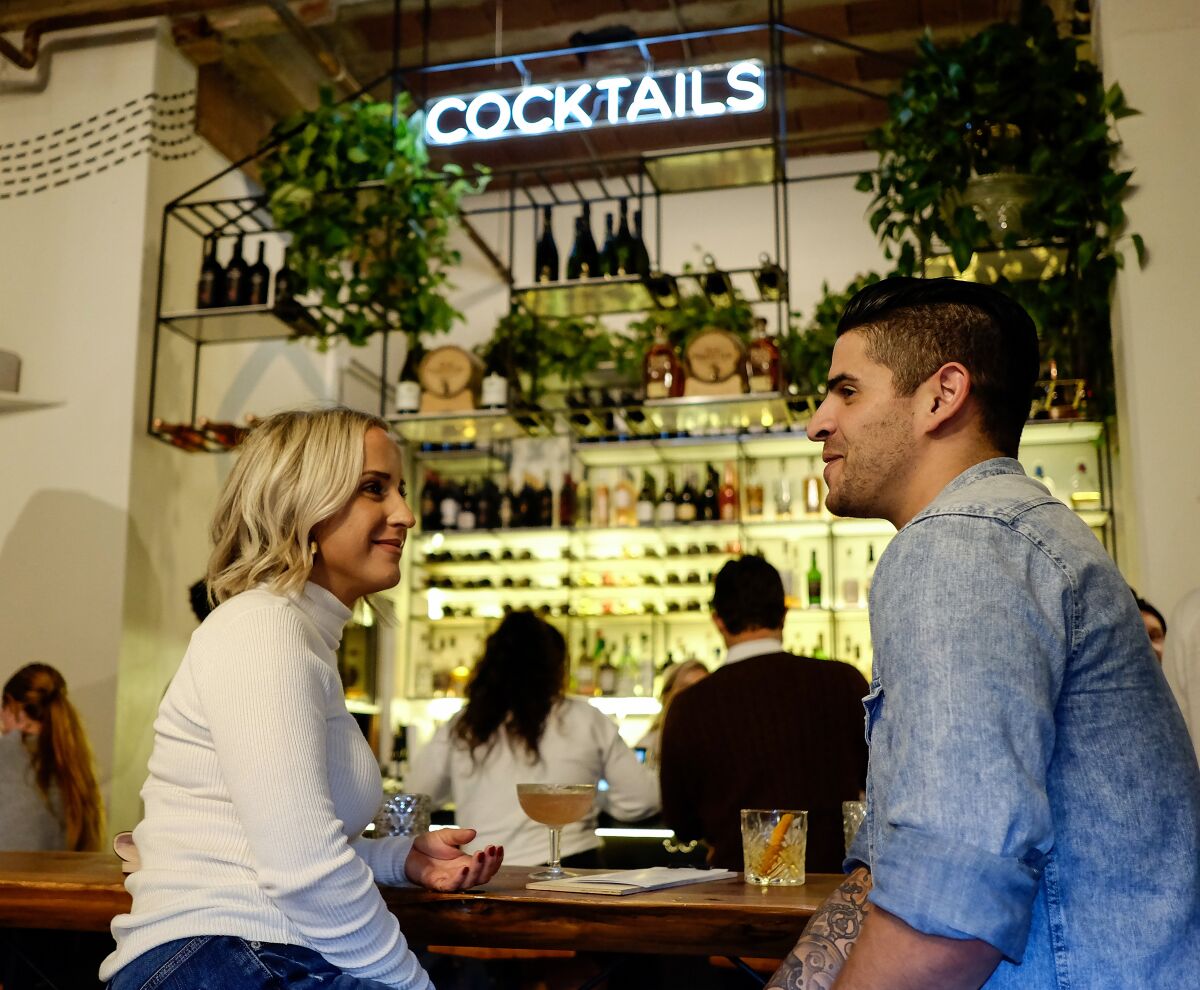 Katlyn (left) and Logan chat while on a blind date at Moniker General in Liberty Station.