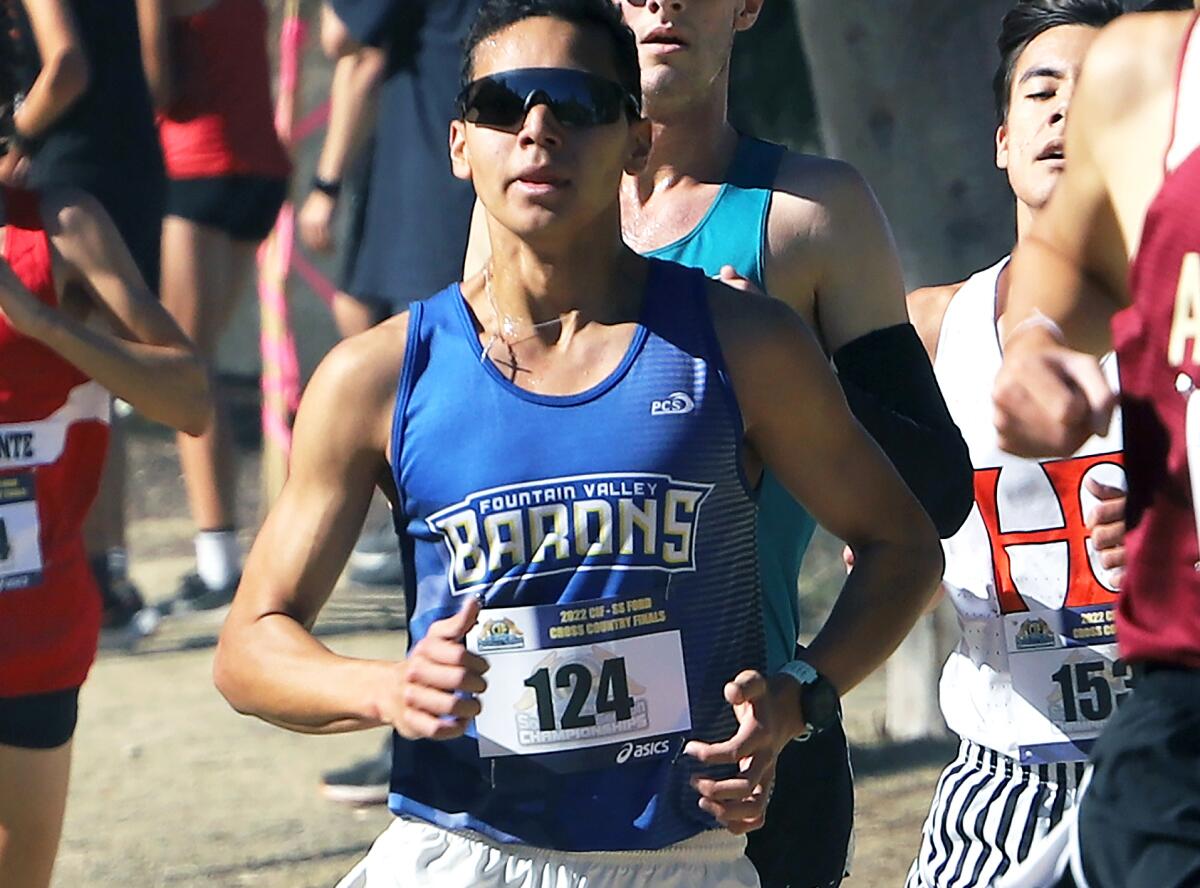 Fountain Valley's Benjamin Prado (124) runs in the boys' Division 1 race of the CIF cross-country finals on Saturday.
