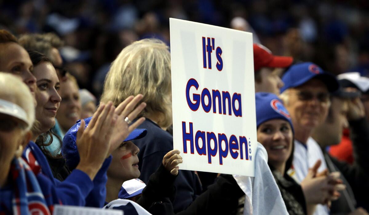 Chicago Cubs fans cheer during Game 4 of the National League Division Series between the Chicago Cubs and the St. Louis Cardinals on Tuesday.