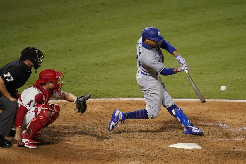 Los Angeles Dodgers' Mookie Betts connects for a solo home run during the seventh inning of the team's baseball game against the Los Angeles Angels on Saturday, Aug. 15, 2020, in Anaheim, Calif. (AP Photo/Marcio Jose Sanchez)
