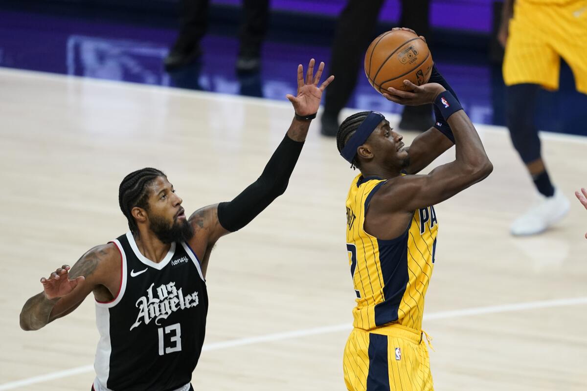Indiana Pacers' Caris LeVert shoots against Clippers' Paul George.
