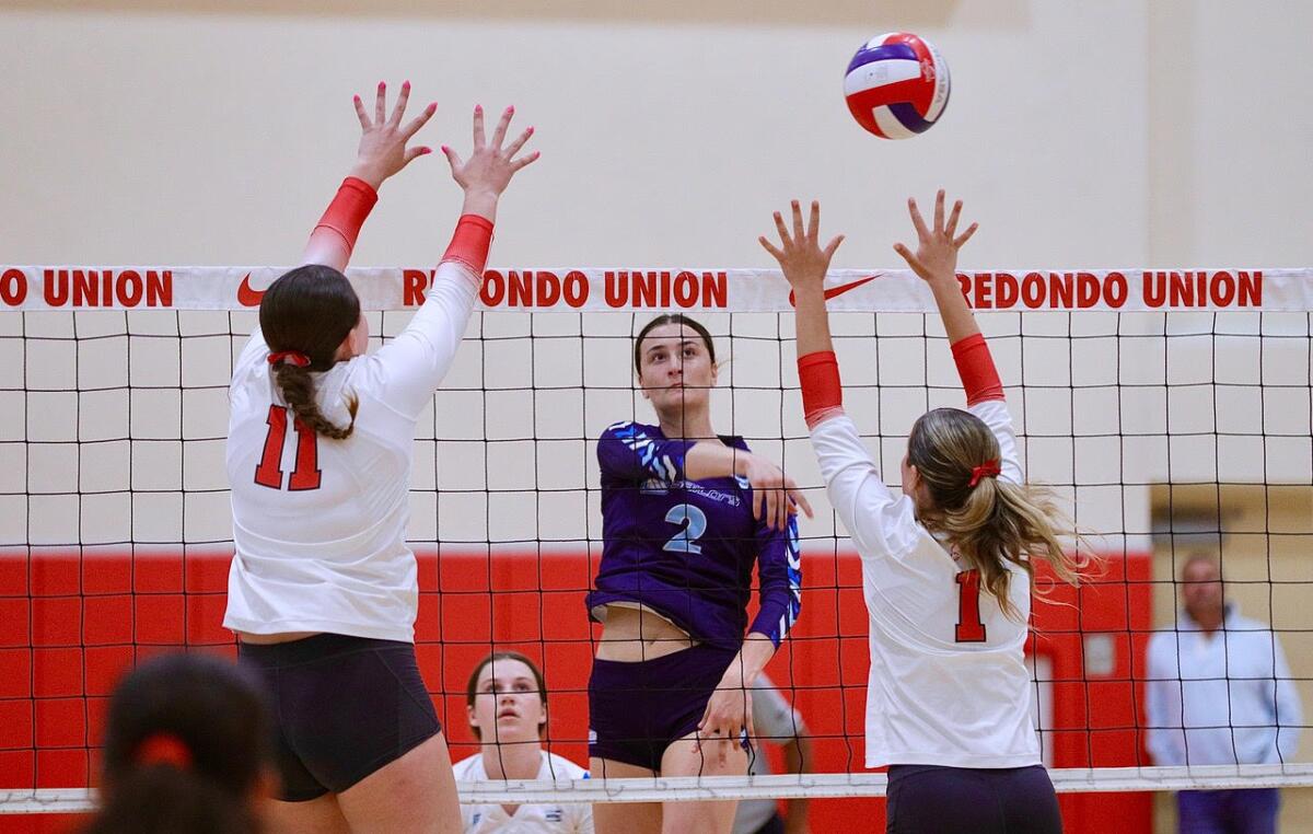 Marymount’s Sammy Destler (facing) on the attack against Redondo Union’s Taylor Boice and Marlo Libbey.