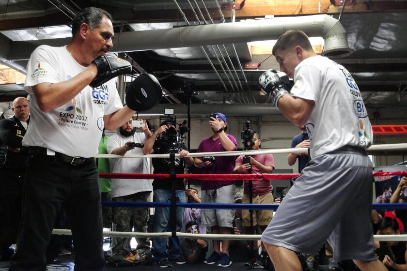 In this photo taken Wednesday, April 20, 2016, Gennady Golovkin, right, spars with his trainer Abel Sanchez, left, for his middleweight title defense at the Wild Card West Boxing Club in Santa Monica, Calif. Golovkin will go for his 22nd consecutive knockout victory when he defends his 160-pound belts in a bout with unbeaten Dominic Wade at the Forum in Inglewood, Calif., on Saturday, April 23. (AP Photo/Greg Beacham)