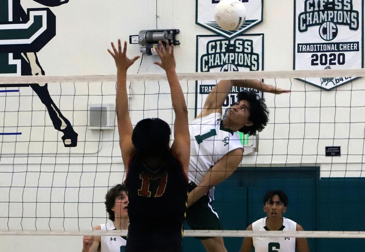 Costa Mesa's Kurt Riley Mateo (1) spikes the ball against Estancia in the Battle for the Bell on Tuesday.