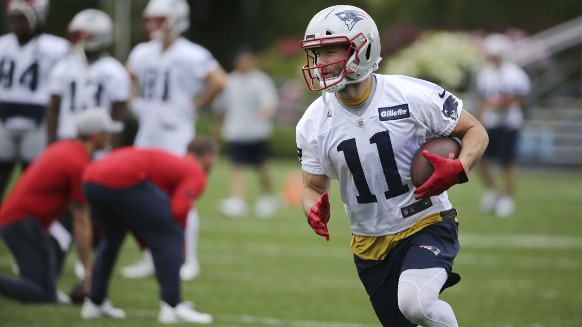 New England Patriots wide receiver Julian Edelman runs with the ball during minicamp on June 6.