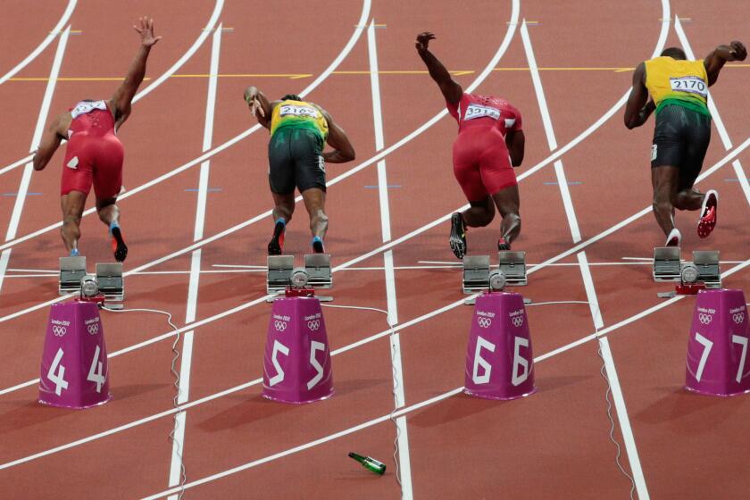 A bottle is thrown onto the track at the start of the men's 100-meter final at the London 2012 Olympic Games on August 5, 2012.