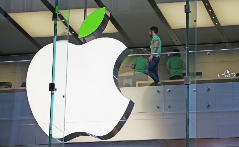 Apple has reportedly launched a team to design electric cars. Above, employees at an Apple store in Sydney, Australia, wear green shirts on Earth Day 2014.