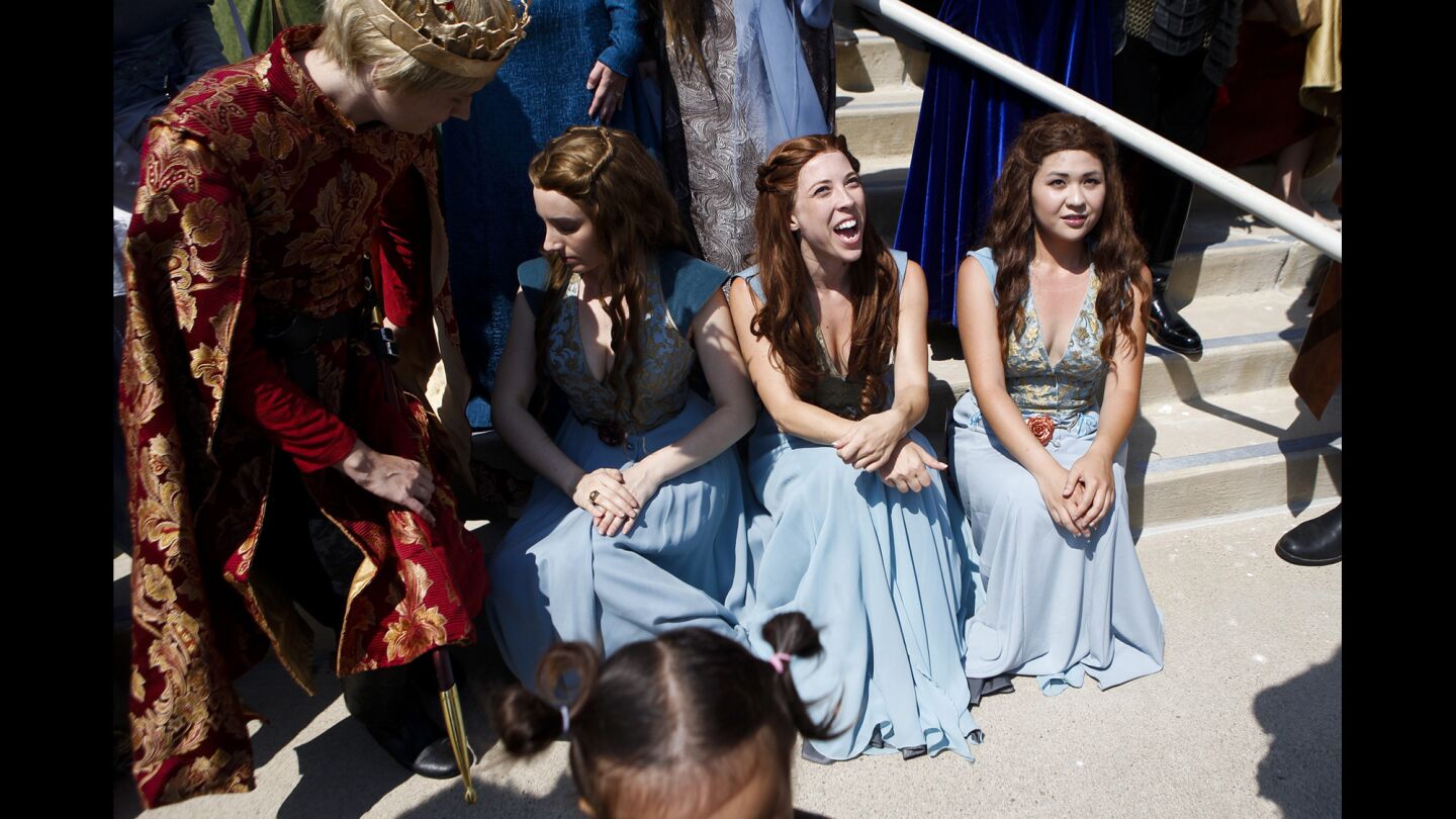 "Game of Thrones" cosplayers sit outside the San Diego Convention center during the third day of Comic-Con.