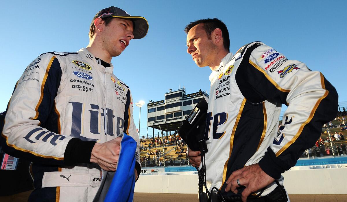 NASCAR driver Brad Keselowski talks to crew chief Paul Wolfe after failing to advance to the final round of the Chase for the Sprint Cup playoff on Sunday at Phoenix International Raceway.