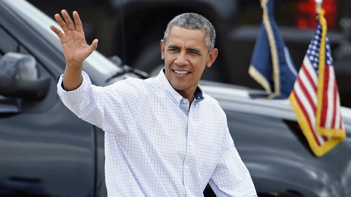 President Barack Obama waves as he leaves Marine Corps Air Station Miramar in San Diego Monday, Oct. 12, 2015. (AP Photo/Denis Poroy)