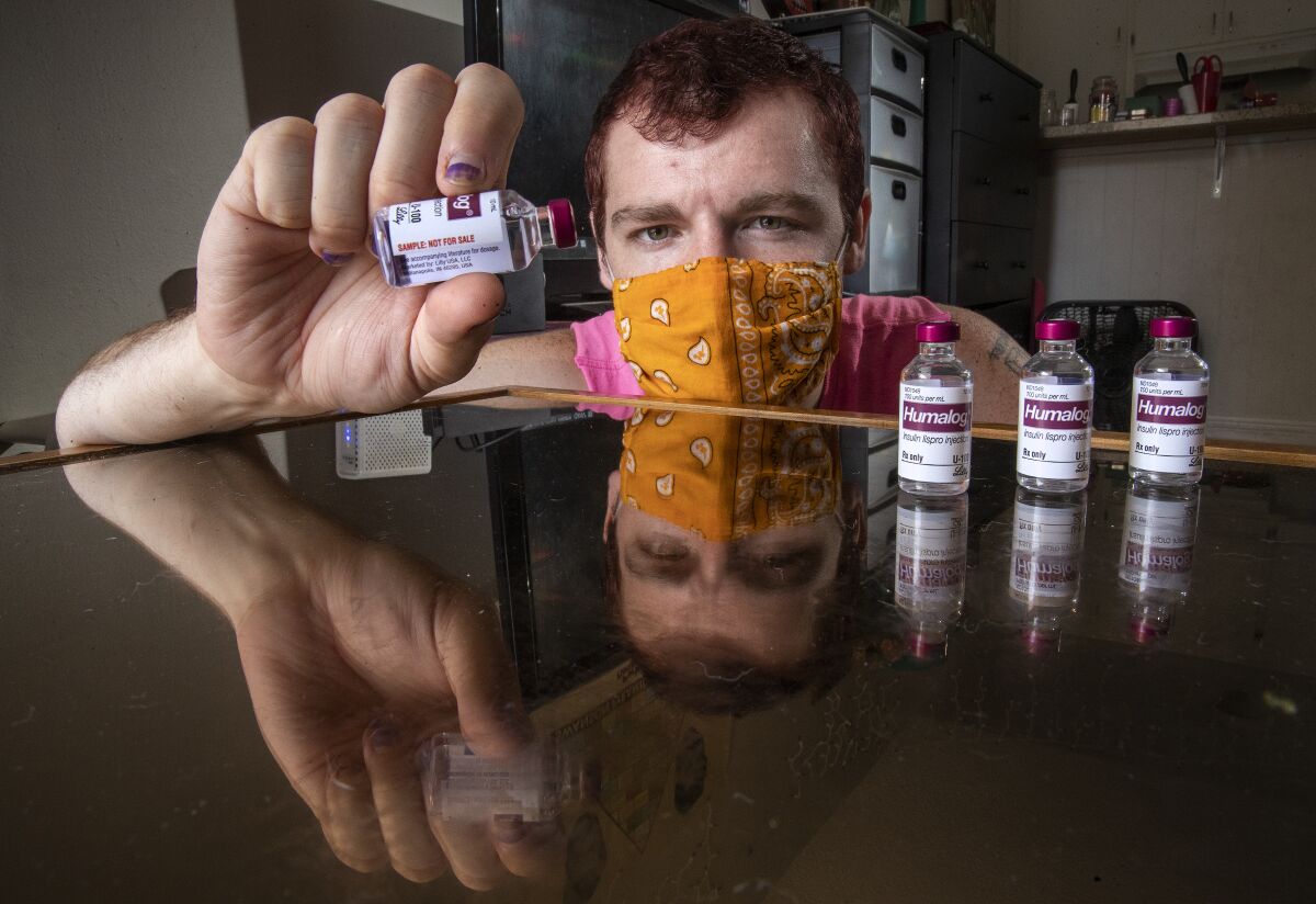 Diabetes patient Adam Winney holds a vial of insulin 