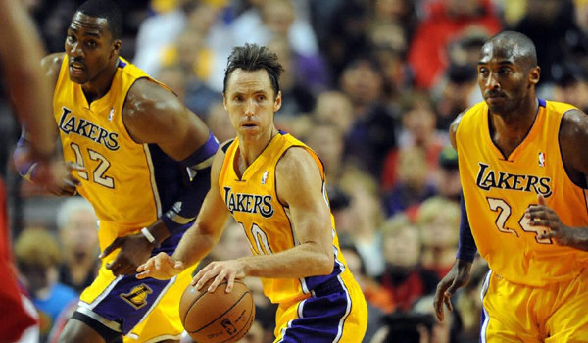 Lakers center Dwight Howard, guards Steve Nash and Kobe Bryant head up the court on a fast break against the Trail Blazers in the first quarter Wednesday.