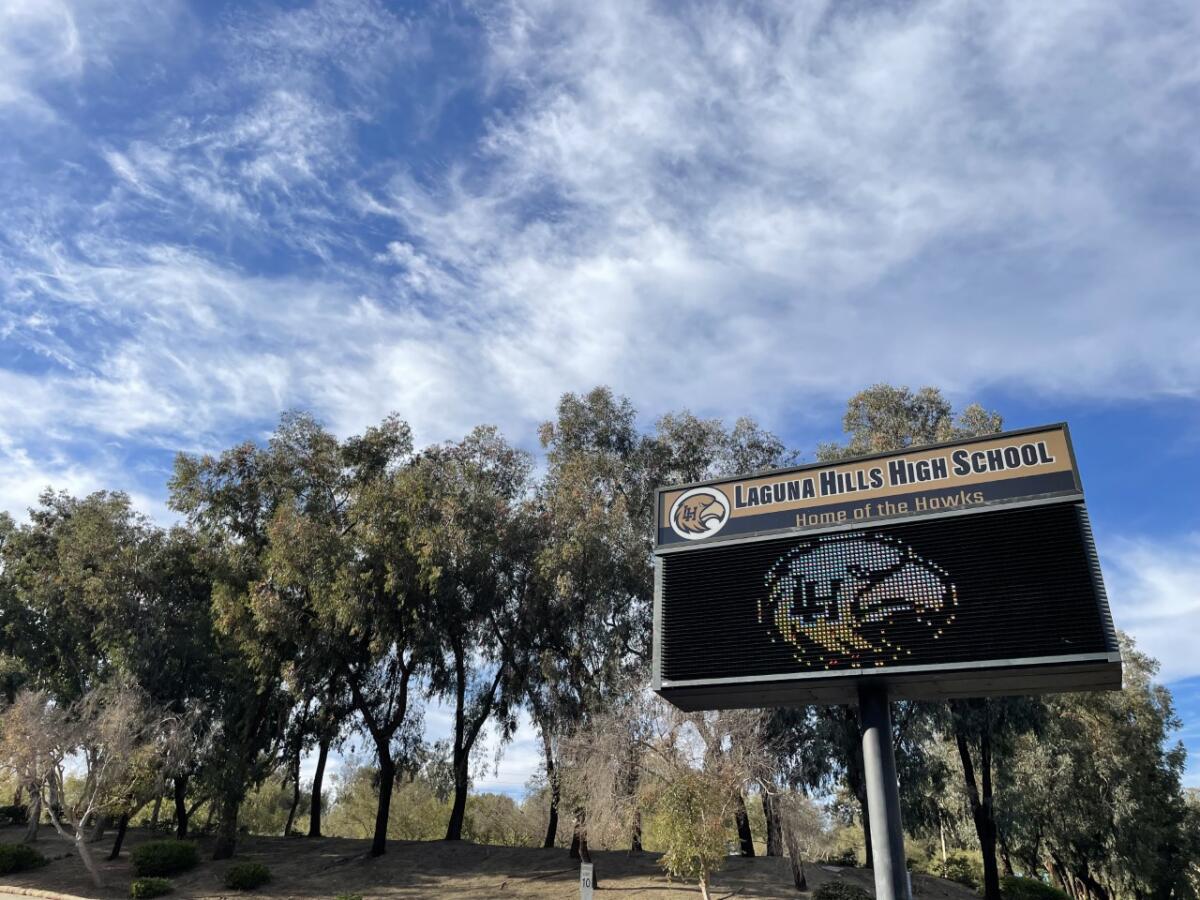 A sign says "Laguna Hills High School, home of the Hawks."