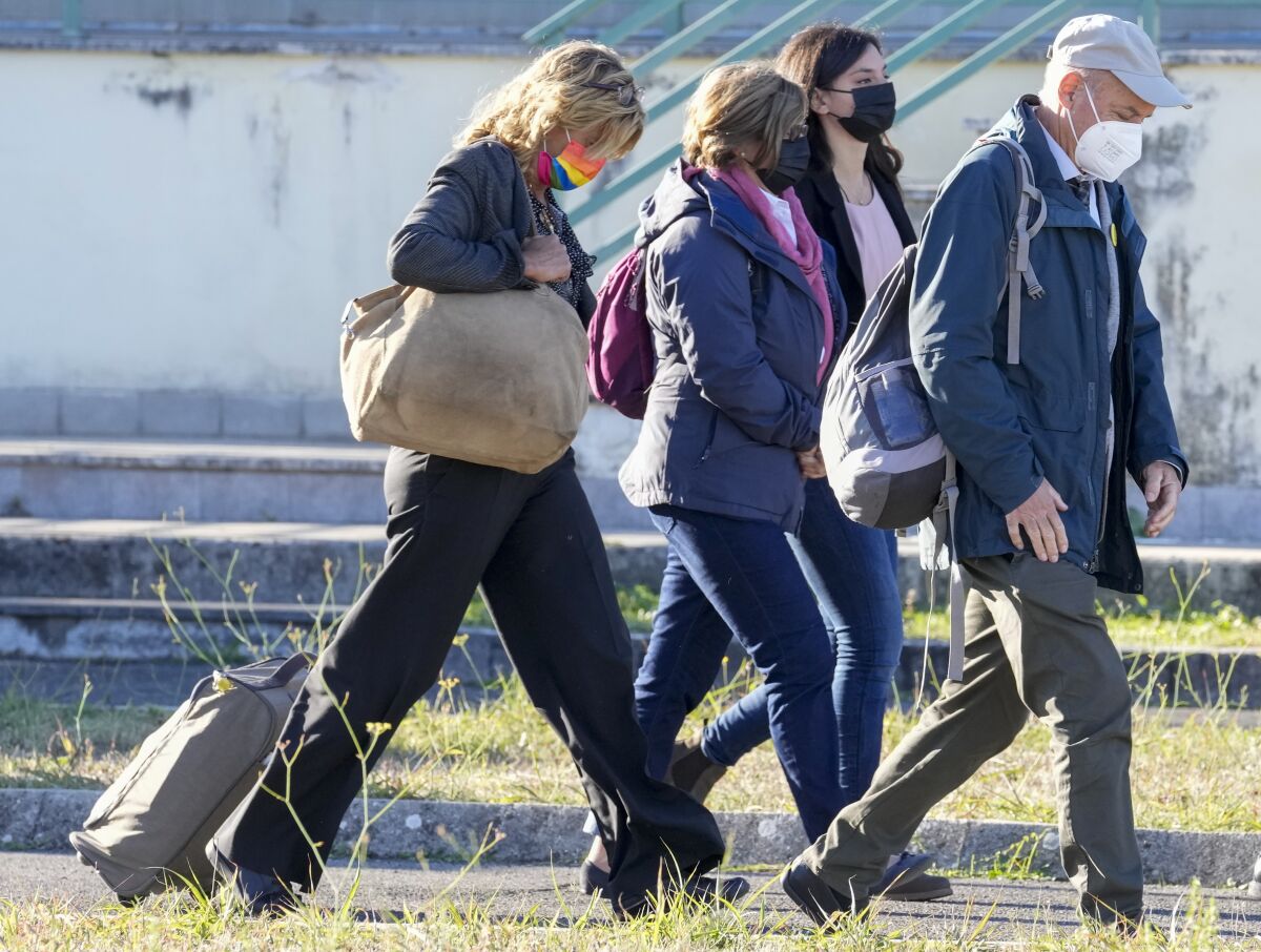 The family of slain Italian doctoral student Giulio Regeni, from left, mother Paola Deffendi, Giulio's sister Irene, and father Claudio Regeni arrive with their lawyer Alessandra Ballerini at the Rebibbia prison in Rome, Thursday, Oct. 14, 2021, to attend the first hearing of the trial for the death of Italian doctoral student Giulio Regeni, who disappeared for several days in January 2016 before his body was found on a desert highway north of the Egyptian capital. Italian prosecutors have formally put four high-ranking members of Egypt's security forces under investigation for their alleged roles in the slaying. (AP Photo/Andrew Medichini)