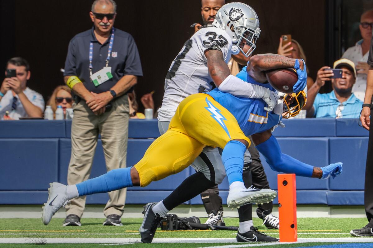 Chargers tight end Gerald Everett (7) pushes into the end zone despite the efforts of Raiders safety Roderic Teamer (33).