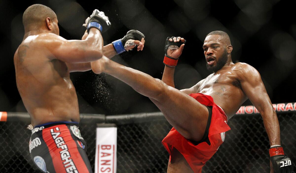 Jon Jones, right, kicks Daniel Cormier during their light heavyweight title mixed martial arts bout at UFC 182 in Las Vegas on Jan. 3.