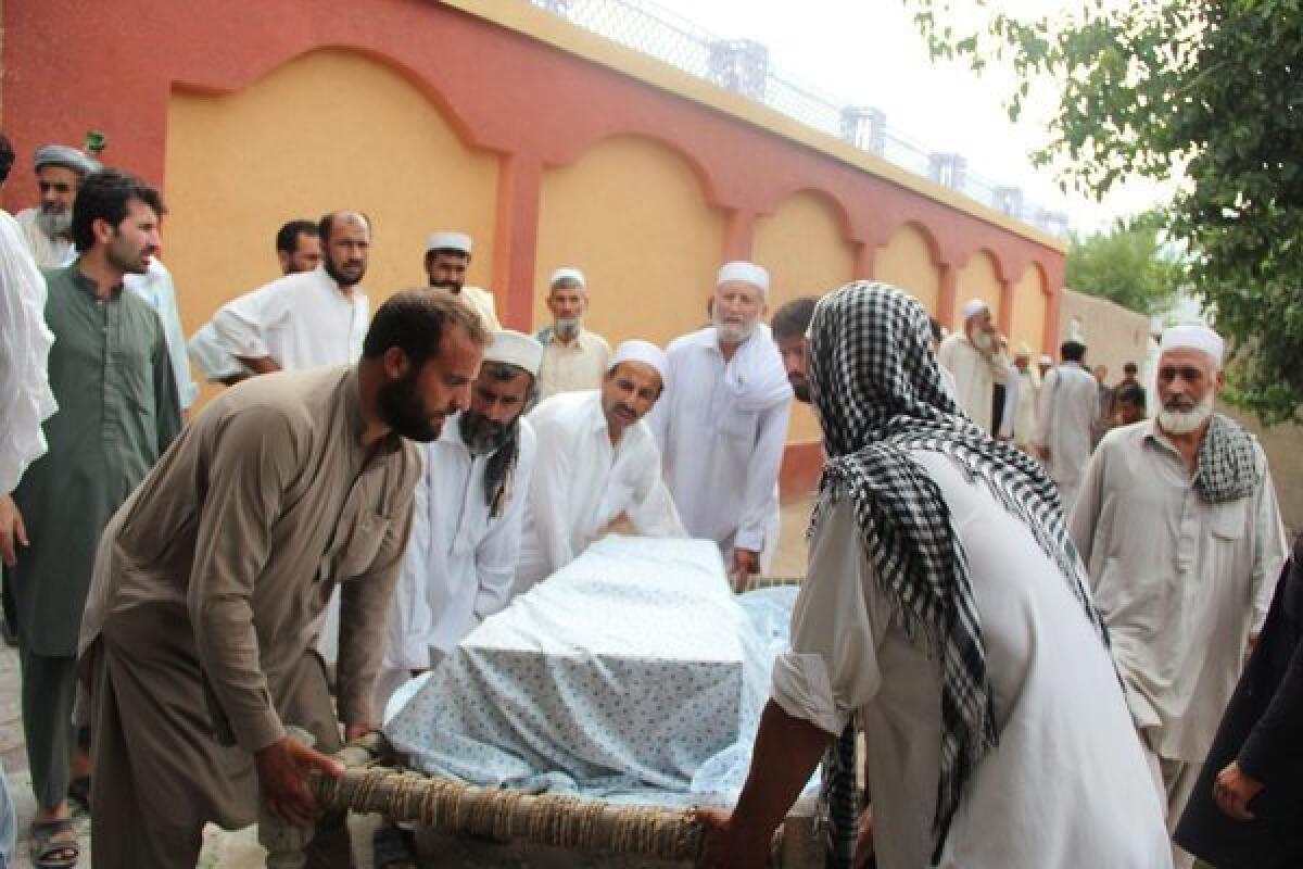 Mourners carry a coffin containing the body of a victim of a suicide bombing that targeted the Indian consulate in Jalalabad, Afghanistan.