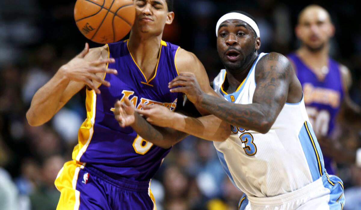 Lakers guard Jordan Clarkson tries to control the ball under pressure from Nuggets guard Ty Lawson in the second half.