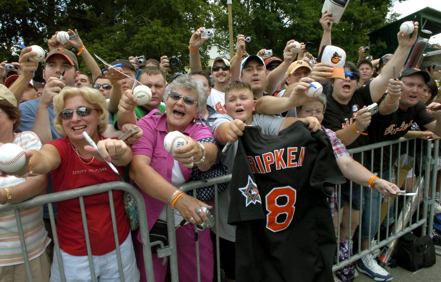 Fans try to get Cal Ripken Jr.'s autograph today after he threw out the ceremonial first pitch at the begining of the Aberdeen Ironbirds and the Oneonta Tigers New York-Penn League game held at Doubleday Field in Cooperstown, N.Y.